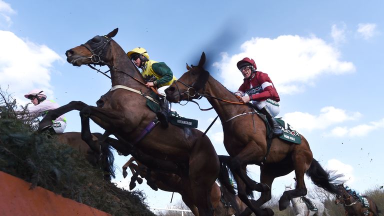 LIVERPOOL, ENGLAND - APRIL 14: Milansbar ridden by Bryony Frost jumps Canal Turn ahead of eventual race winner Tiger Roll ridden by Davy Russell during the 2018 Randox Health Grand National at Aintree Racecourse on April 14, 2018 in Liverpool, England. (Photo by Laurence Griffiths/Getty Images)
