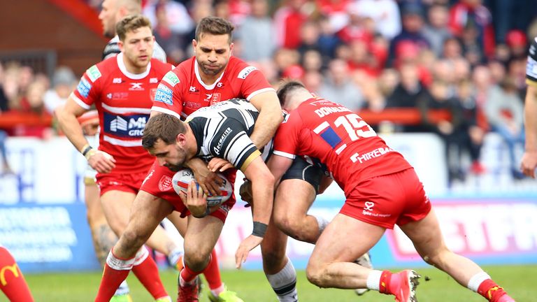 Josh Bowden of Hull FC is tackled by James Donaldson and Maurice Blair of Hull KR during the BetFred Super League match between Hull KR and Hull FC at KCOM Craven Park on March 30, 2018 in Hull, England. 