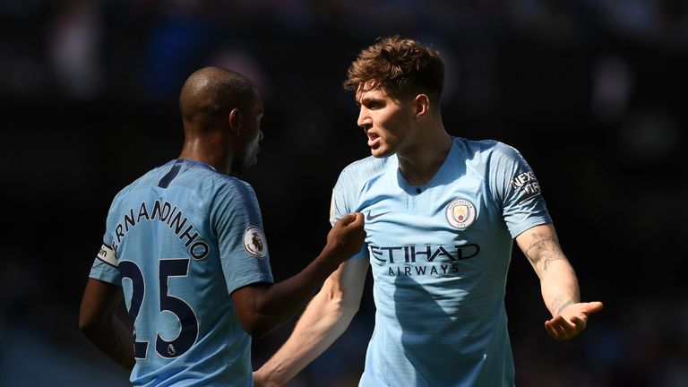 John Stones talks to teammate Fernandinho of Manchester City during the Premier League match between Manchester City and Tottenham Hotspur at Etihad Stadium on April 20, 2019 in Manchester, United Kingdom.