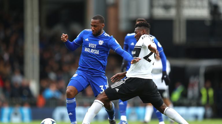 Junior Hoilett of Cardiff City battles for possession with Andre-Frank Zambo Anguissa of Fulham