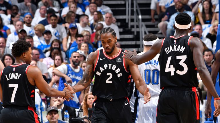 Kawhi Leonard #2 of the Toronto Raptors high-fives Kyle Lowry #7 of the Toronto Raptors and Pascal Siakam #43 of the Toronto Raptors against the Orlando Magic during Game Four of Round One of the 2019 NBA Playoffs on April 21, 2019 at Amway Center in Orlando, Florida.