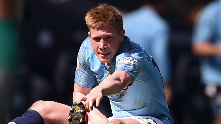 Kevin De Bruyne receives treatment on the pitch after going down injured