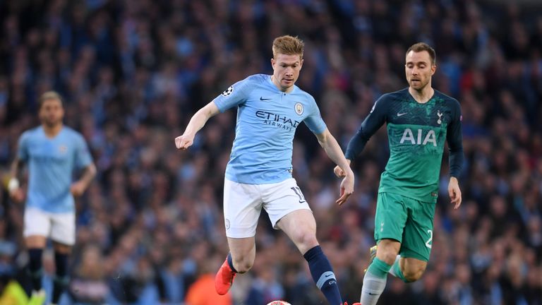 Kevin de Bruyne drives away from Christian Eriksen during a frantic first half
