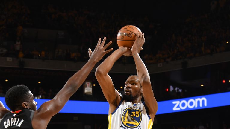 Kevin Durant shoots over an outstretched Clint Capela