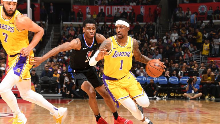 Kentavious Caldwell-Pope of the Los Angeles Lakers drives past Shai Gilgeous-Alexander of the LA Clippers