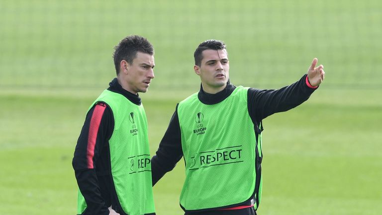 Arsenal are sweating on the fitness of Laurent Koscielny (L) and Granit Xhaka (R)