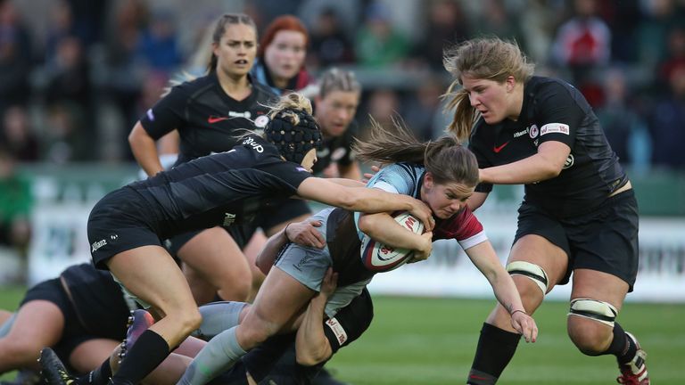 Leanne Riley of Harlequins Ladies tis tackled by Lauren Newman and Poppy Cleall of Saracens Women during the Tyrrells Premier 15s Final match between Saracens Women and Harlequins Ladies at Franklin&#39;s Gardens on April 27, 2019 in Northampton, England. 