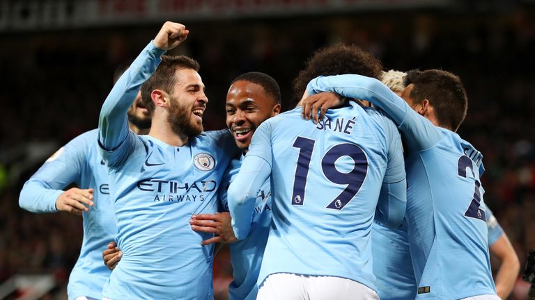 Leroy Sane is mobbed by his team-mates after putting Manchester City 2-0 up