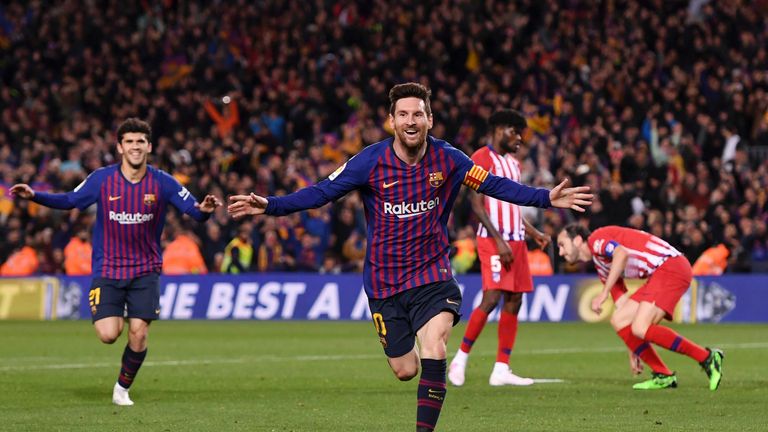 Lionel Messi celebrates his 33rd league goal of the season against Atletico Madrid