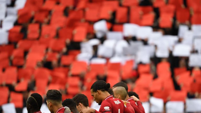 Liverpool players observed a minute's silence before the match