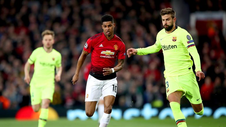 Manchester United forward Marcus Rashford battles for possession with Barcelona's Gerard Pique