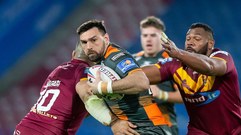  Castleford's Matt Cook is tackled by Huddersfield's Suai Matagi & Ukuma Ta'ai.