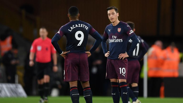 Mesut Ozil and Alexandre Lacazette get ready to kick-off with their team trailing at Molineux