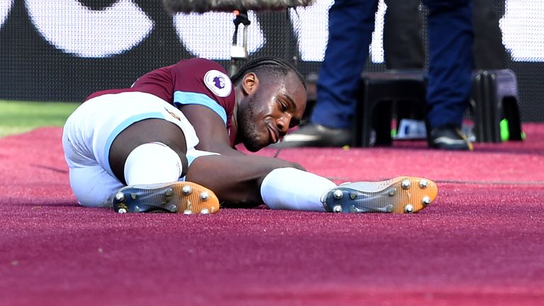 Michail Antonio celebrates his goal by stroking West Ham's new claret pitchside carpet