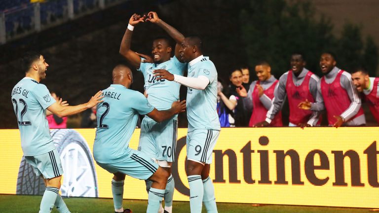 New England Revolution's Cristian Penilla celebrates with team-mates after scoring against the New York Red Bulls.