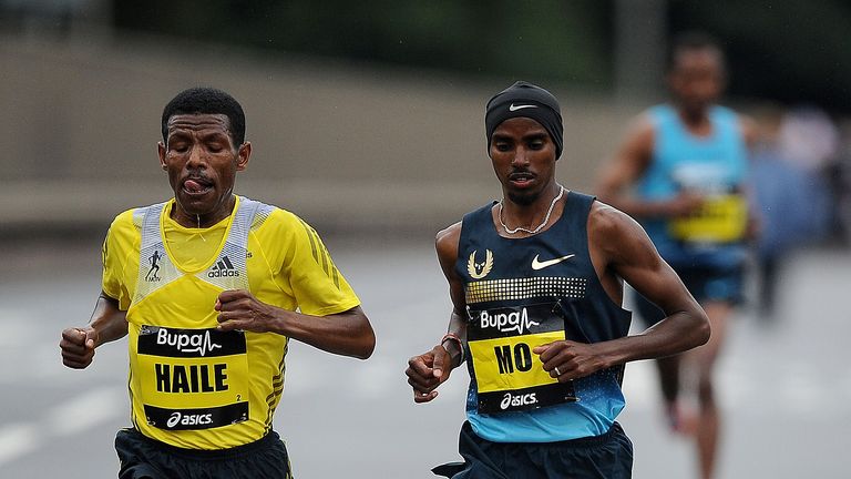 Haile Gebrselassie (L) and Mo Farah race during the Great North Run on September 15, 2013 in Gateshead, England.