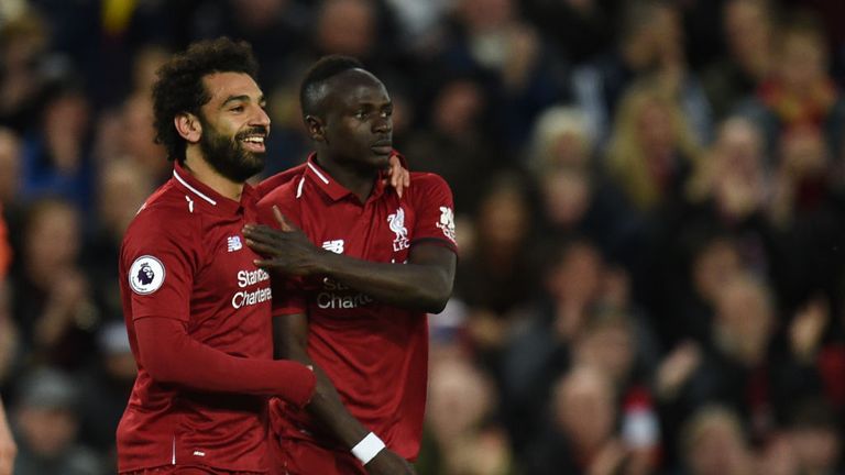 Sadio Mane (R) celebrates with Liverpool's Mohamed Salah after scoring the team's second goal during the  Premier League football match between Liverpool and Huddersfield at Anfield
