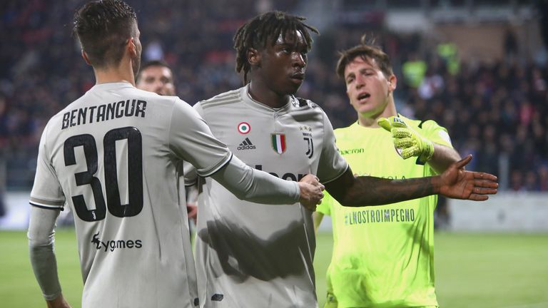 Rodrigo Bentancur attempts to guide Juventus team-mate Moise Kean away from Cagliari fans who racially abused him