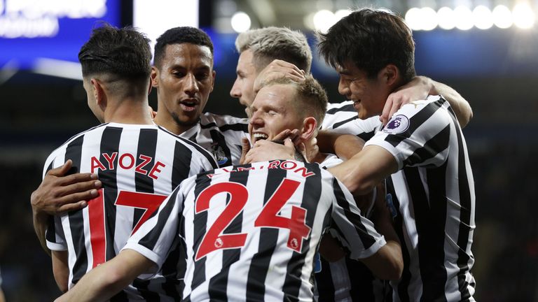 Newcastle United's Scottish midfielder Matt Ritchie (C) celebrates with teammates after putting in the cross for the opening goal, scored by Newcastle United's Spanish striker Ayoze Perez (L) during the English Premier League football match between Leicester City and Newcastle United at King Power Stadium in Leicester, central England on April 12, 2019