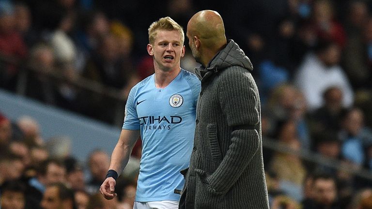 Oleksandr Zinchenko speaks with Pep Guardiola as he's substituted in the first-half 