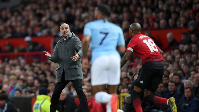Pep Guardiola urges his team on at Old Trafford