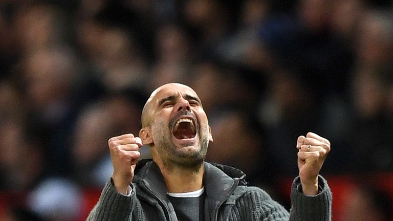 Pep Guardiola pumps his fists in celebration after Leroy Sane puts Manchester City 2-0 up