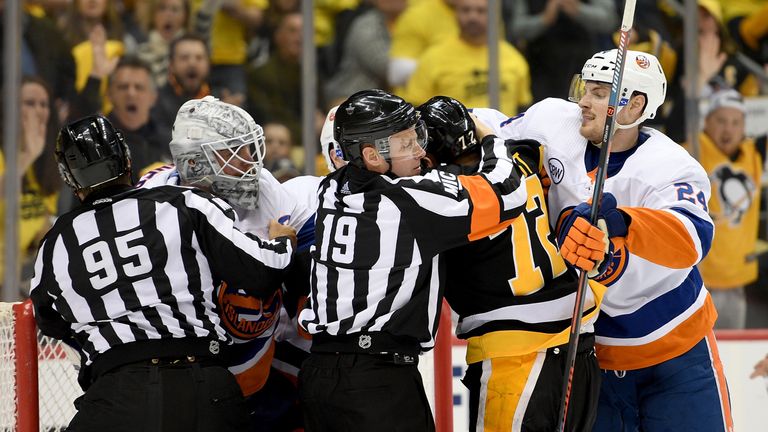 Robin Lehner of the New York Islanders exchanges punches with Patric Hornqvist of the Pittsburgh Penguins 