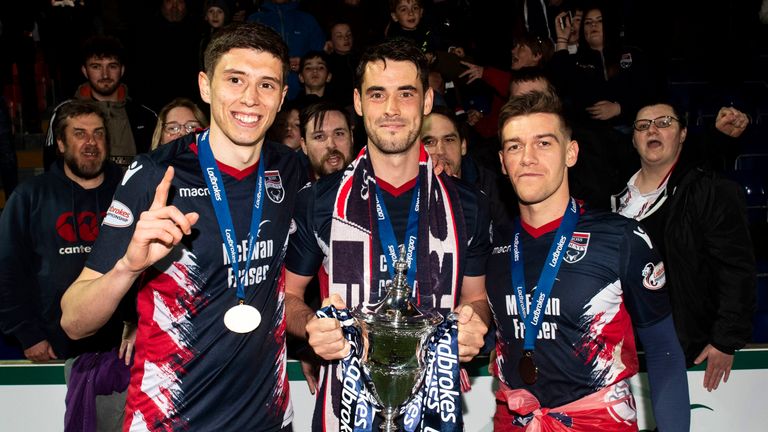 Ross County players Ross Stewart, Brian Graham and Josh Mullin celebrate winning the Scottish Championship trophy with a 4-0 win over Queen of the South