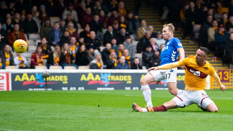 Arfield beats Motherwell’s Tom Aldred to the ball to open the scoring