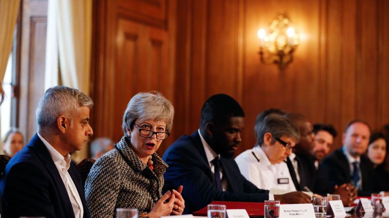 Britain's Prime Minister Theresa May (2L) hosts a Serious Youth Violence Summit flanked by London Mayor Sadiq Khan (L), Youth Justice Board co-chair Roy Sefa-Attakora (3L) and Metropolitan Police commissioner Cressida Dick (4L) at 10 Downing Street in central London on April 1, 2019. 