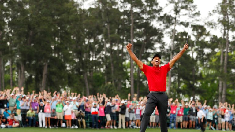 Tiger Woods celebrates after sinking his putt to win The Masters 2019