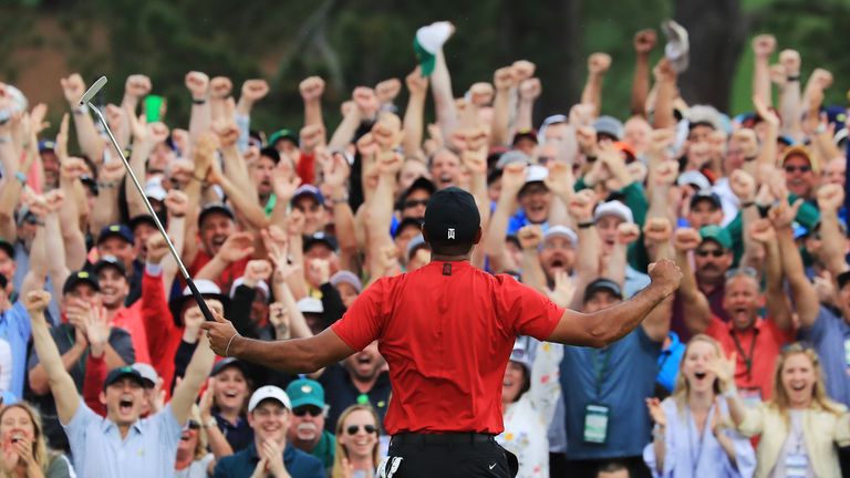 Tiger Woods celebrates in front of the crowd at Augusta after sinking his putt to win The Masters 2019