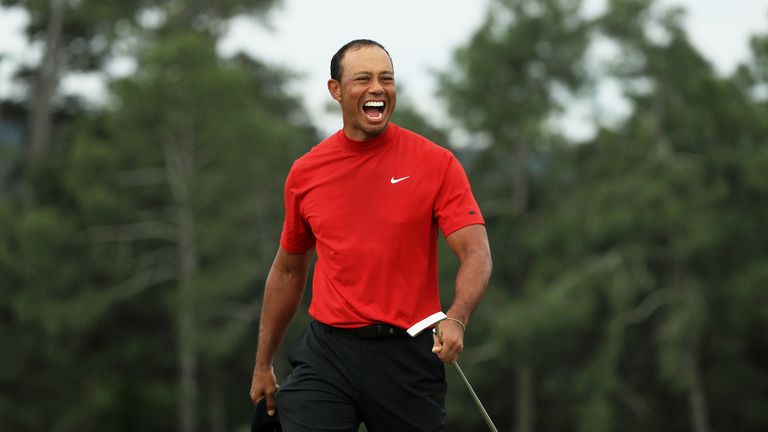 Tiger Woods celebrates after sinking his putt on the 18th green to win The Masters 2019