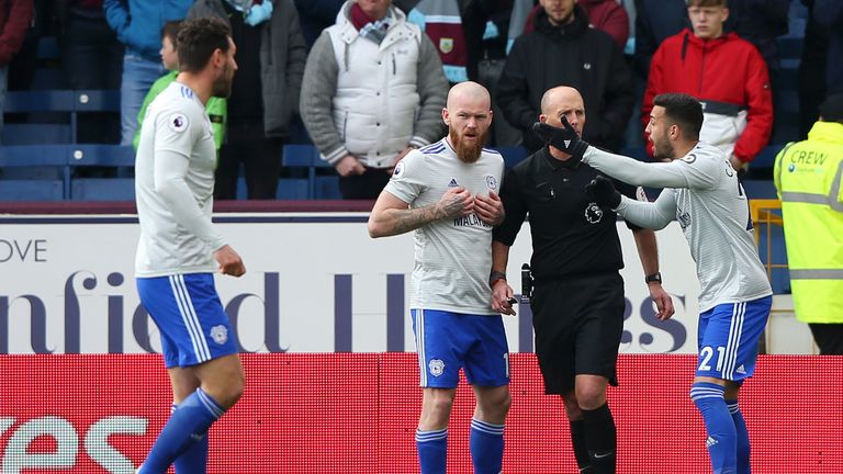 Victor Camarasa and Aron Gunnarsson remonstrate with referee Mike Dean following an appeal for a penalty at Turf Moor