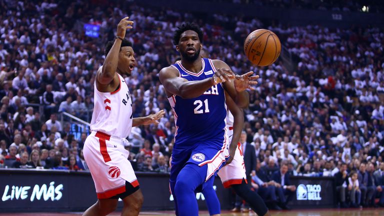 Joel Embiid throws a pass in Game 2 against the Raptors