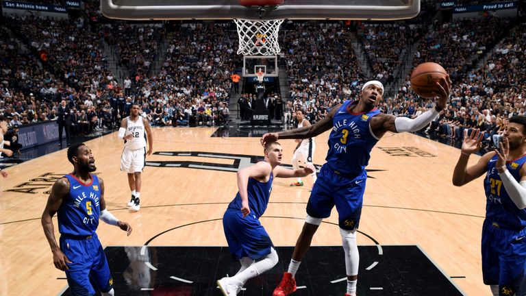 Torrey Craig snags a rebound against the San Antonio Spurs