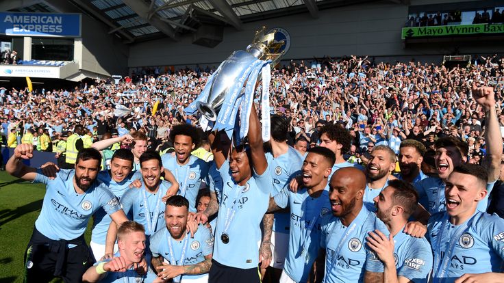 Fernandinho celebrates with the Premier League trophy after Manchester City win the title