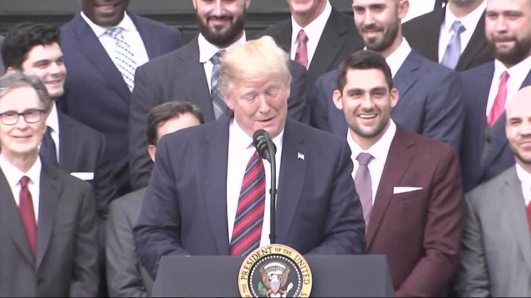 President Donald Trump is presented with a Boston Red Sox baseball team  jersey by Red Sox outfielder J. D. Martinez, during a ceremony on the South  Lawn of the White House in