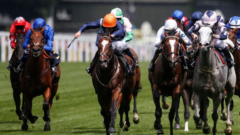 Charles Bishop riding Accidental Agent (orange cap) to victory at Ascot