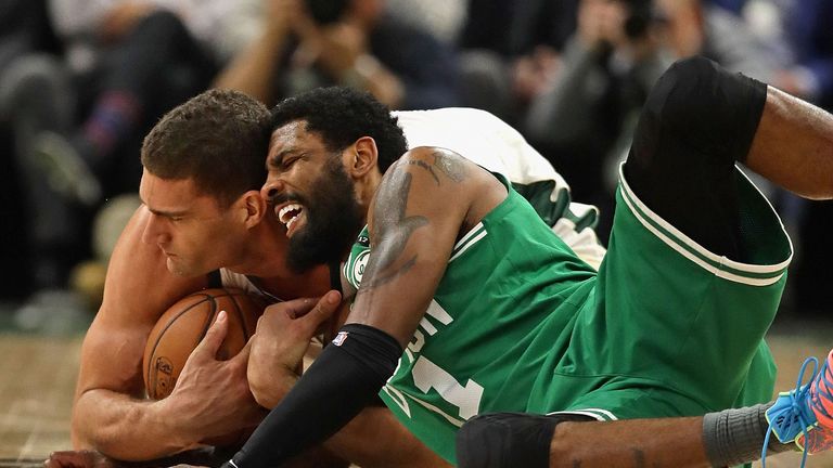 Kyrie Irving battles Brook Lopez for a loose ball