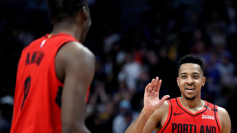 CJ McCollum celebrates a Portland play in Game 2 against the Nuggets