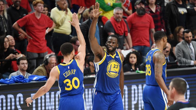 Draymond Green high-fives team-mate Stephen Curry during Game 4 of the Western Conference Finals