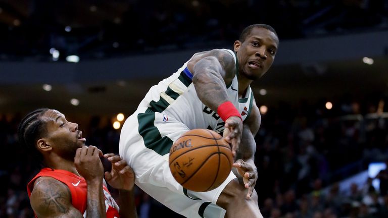 Eric Bledsoe throws an off-balance pass in mid-air under pressure from the Toronto defense