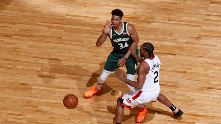 Giannis Antetokounmpo throws a pass beyond the reach of Kawhi Leonard in Game 4 of the Eastern Conference Finals