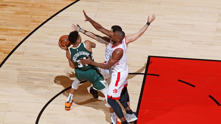 Giannis Antetokounmpo is walled off in the paint in Game 4