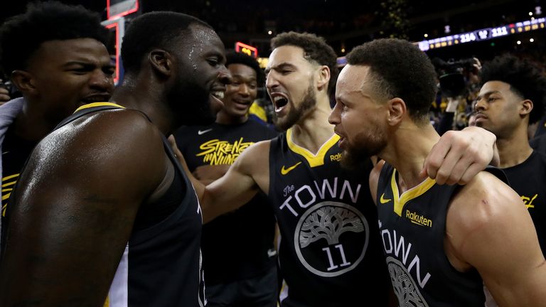 Draymond Green, Klay Thompson and Stephen Curry celebrate Golden State's Gane 2 win over the Portland Trail Blazers