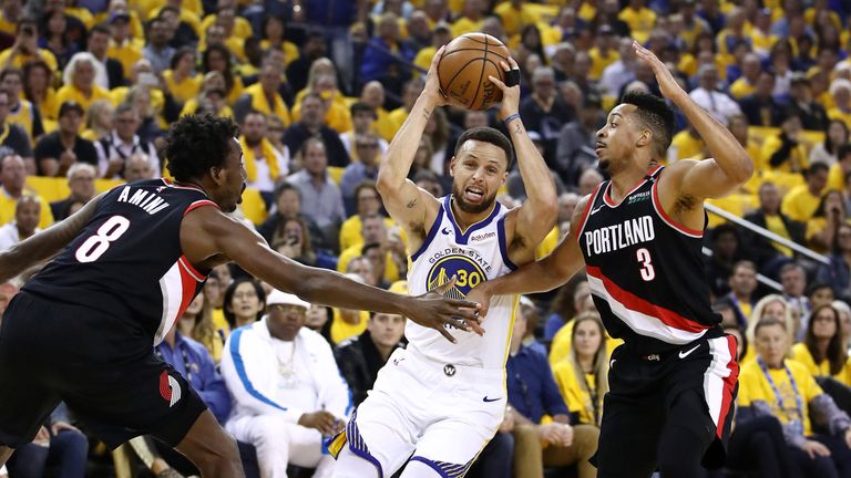 Stephen Curry drives at CJ McCollum in Game 1 of the Western Conference Finals