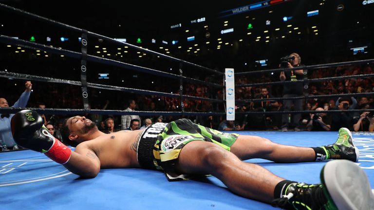 Dominic Breazeale lies on the canvas after being knocked out by Deontay Wilder