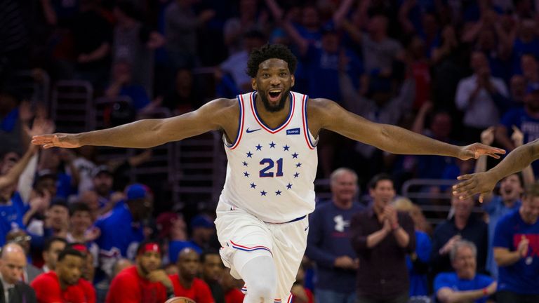 Joel Embiid se aleja en la celebración después de sacudir el borde con una gran volcada en el molino de viento