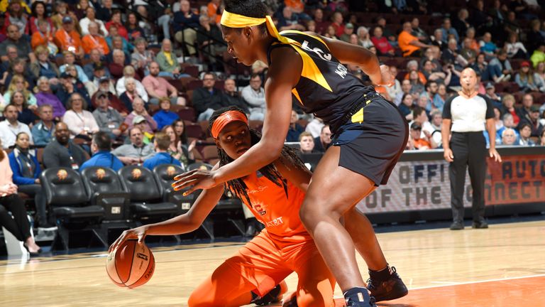 Jonquel Jones keeps her dribble despite being knocked to the floor against the Indiana Fever